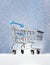 Trolley for shopping on a pedestal on a winter blue background. Best Buyer, Best Buy.
