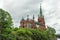 Trollhattan, Sweden - Aug 27, 2021: Low angle view of the a church with lush vegetation and trees