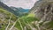Trollstigen, Andalsnes, Norway. Cars Goes On Serpentine Mountain Road Trollstigen. Famous Norwegian Landmark And Popular