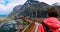 Trollstigen, Andalsnes, Norway - June 19, 2019: Young Caucasian Woman Tourist Traveler Walking Viewing Platform Near