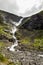 Trollstigen waterfall on serpentine mountain road, Norway