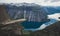 Trolltunga - famous rock formation and tourist famous hike, beautiful norwegian summer landscape with fjord, mountain and lake