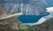 Trolltunga - famous rock formation and tourist famous hike, beautiful norwegian summer landscape with fjord, mountain and lake