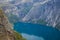 Trolltunga - famous rock formation and tourist famous hike, beautiful norwegian summer landscape with fjord, mountain and lake