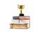 Trophy and book with pencil on white