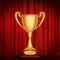 Trophy golden cup on red curtain background