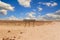 Tropic of Capricorn sign at a desert dirt road in Namibia under a blue sky over the sand on a hot day.