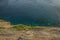 Tropic vivid colorful mountain rocks and blue green water surface with waves from above in warm colorful summer day weather