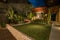 Tropical Backyard Garden at Night with Various of Plants