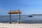 Tropical beach background as summer landscape with beach swing and white sand and calm sea for beach banner. Perfect beach scene.