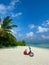 Tropical beach background as summer landscape. Red moped or motorcycle on the beach. Perfect beach scene vacation and summer