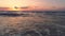 Tropical beach and beautiful sea sunrise. Dramatic clouds and dancing waves.