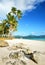 Tropical beach with a boat on a background of mountains islands