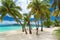 Tropical beach with coconut palm trees and lagoon on Fiji Island