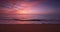 Tropical beach and colorful ocean sunrise over sea waves and sandy shore