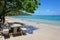 Tropical beach with concrete picnic table on sand