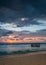 Tropical Beach with Empty Cage in the Sea at Sunset