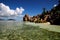 Tropical beach with granitic rocks and blue water