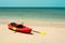 Tropical beach landscape with red canoe boat