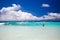 Tropical beach, man enjoy turquoise waves of ocean