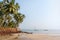 Tropical beach with palm, India, Goa. Blue sky and blue sea