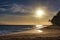 Tropical beach and palm tree on Maui with fiery sky.