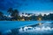 Tropical beach with palm trees and resort lights at night