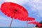 Tropical beach with red umbrellas