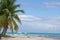 Tropical beach on Saona Island, white yacht in a distance in clear blue water, Dominican Republic