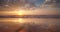 Tropical beach sunrise with golden sun rays over the sand and sea