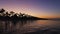 Tropical beach at sunset. Romantic night, glowing lights over the sea water