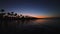 Tropical beach at sunset. Romantic night, glowing lights over the sea water