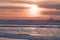 Tropical beach sunset in soft blue and pink colors. Empty sand beach, huge waves, and beautiful cloudy sky