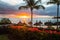 Tropical beach with thatched umbrellas and a setting down sun over a calm seascape in Mauritius