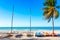 The tropical beach of Varadero in Cuba with sailboats and palm tree on a summer day with turquoise water ocean. Vacation