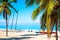 The tropical beach of Varadero in Cuba with sailboats and palm trees on a summer day with turquoise water. Vacation background