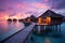 Tropical beach with water bungalows at sunset, Maldives, Water villas on Maldives resort island in sunset, AI Generated