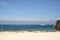 Tropical beach with white sand, blu sea, blu sky and sailboats