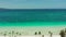 Tropical beach with white sand and palm trees, view from above. Turquoise lagoon with a sandy bottom.