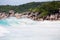 Tropical beach, wild waves, turquise water of the Indian ocean next to typical granite rocks of Seychelles