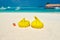 Tropical beach with yellow beanbag chairs