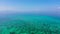 Tropical blue sea and blue sky with clouds. Mountains on the horizon.