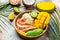 tropical bowl with avocado, prawns, rice, mango, kiwi and coconut, tropical food on the sea beach, Organic and healthy food, place