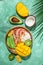 tropical bowl with avocado, prawns, rice, mango, kiwi and coconut, tropical food on the sea beach, Organic and healthy food, place