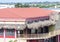 Tropical Building with Red Tile Roof and Thatched Awnings