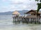 Tropical bungalows with thatched roof on high stilts