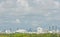 Tropical, cityscape, cloudy skies, with a ridge of green tree line