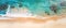 Tropical coastline with turquoise water waves washing the sandy shore. Top view. Bird\\\'s-eye view. 21 to 9 aspect ratio
