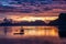 Tropical colorful sunset with a banca boat in El Nido