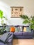 Tropical cozy living room with numerous houseplants and vintage insect poster on the wall